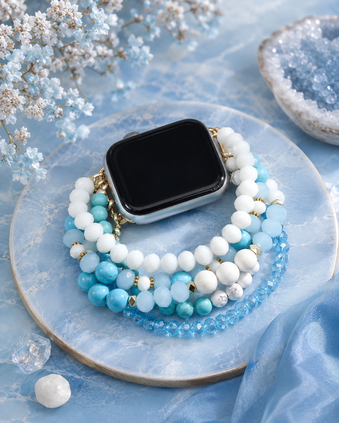 Smartwatch with multiple beaded bands on a decorative plate with flowers and crystals.