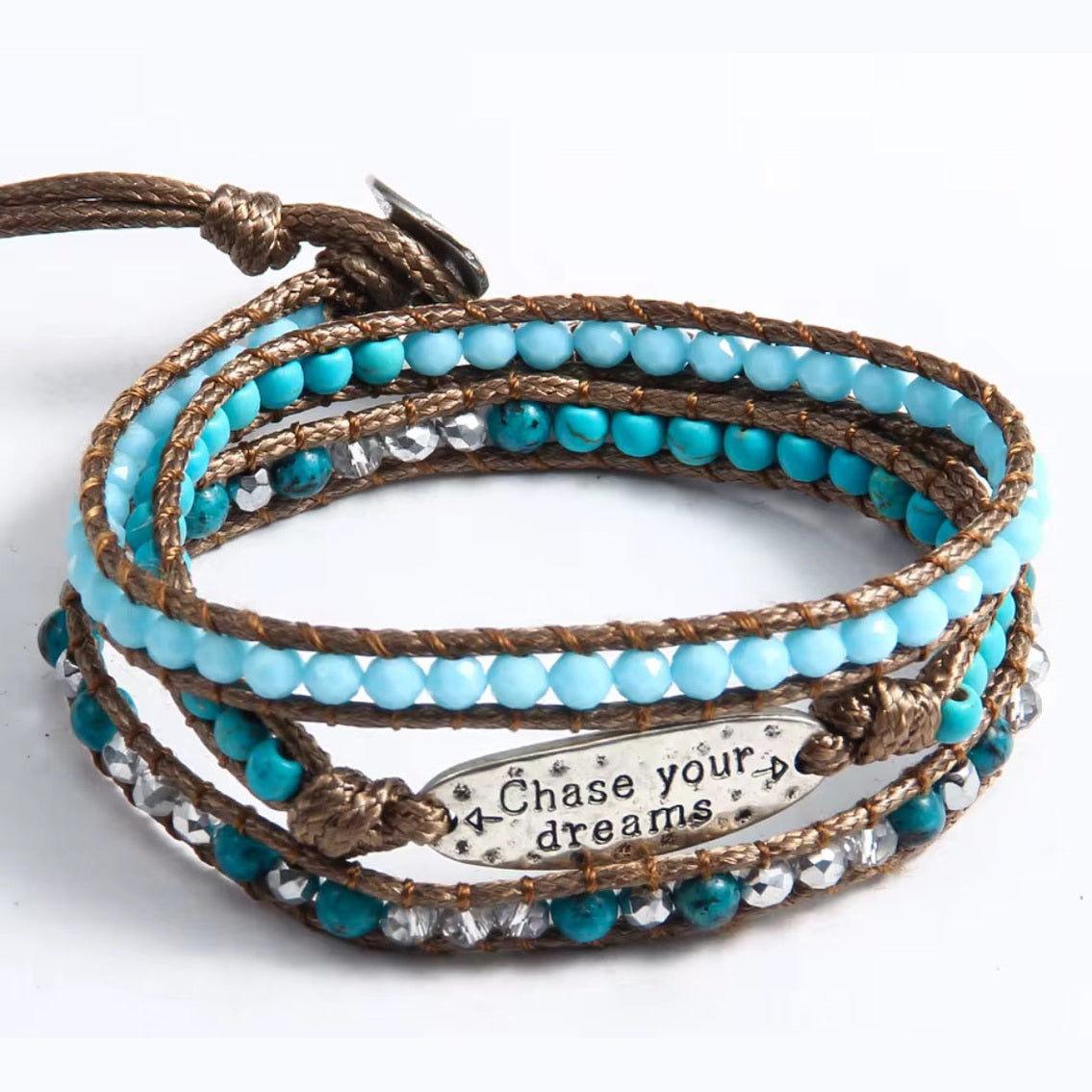 Turquoise beaded bracelet with metal charm on a white background