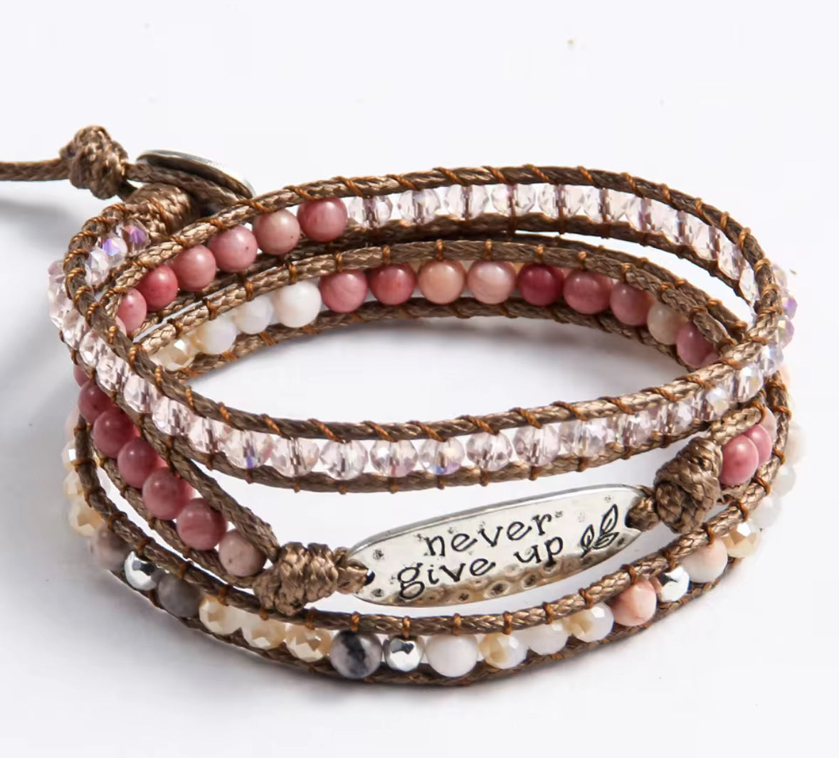 Multistrand beaded bracelet with 'never give up' message on a white background