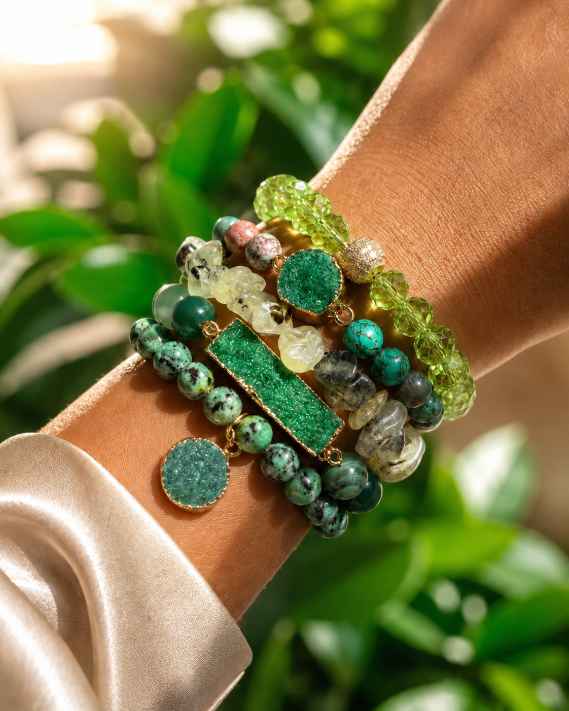 Stack of green beaded bracelets on a wrist with a blurred natural background
