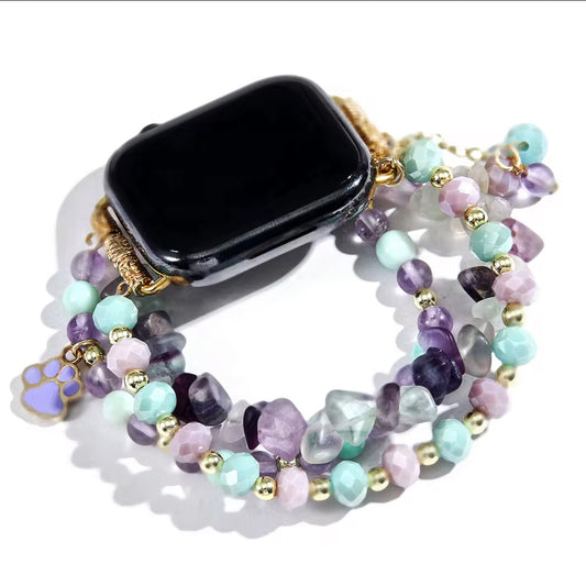 Multicolored beaded bracelet with a black smartwatch on a white background
