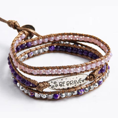 Multistrand beaded bracelet with 'BE BRAVE' charm on a white background