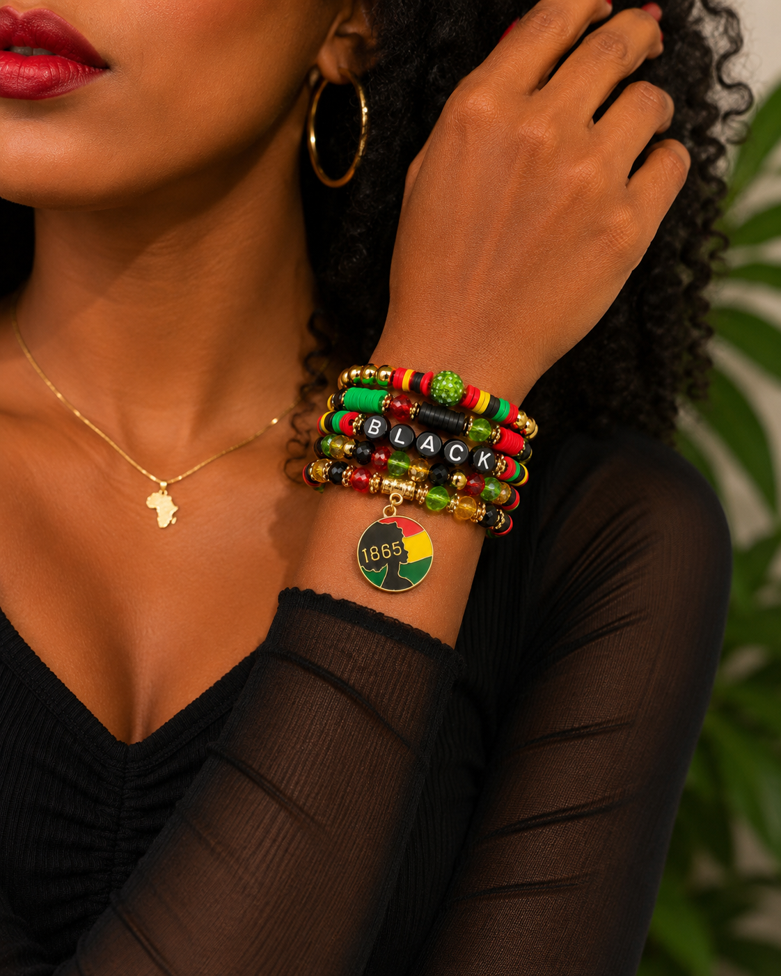 Close-up of a person wearing colorful beaded bracelets with 'BLACK' and a heart pendant, set against a blurred background.