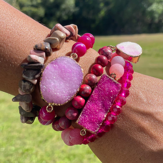 Multicolored beaded bracelets on a wrist with a natural background