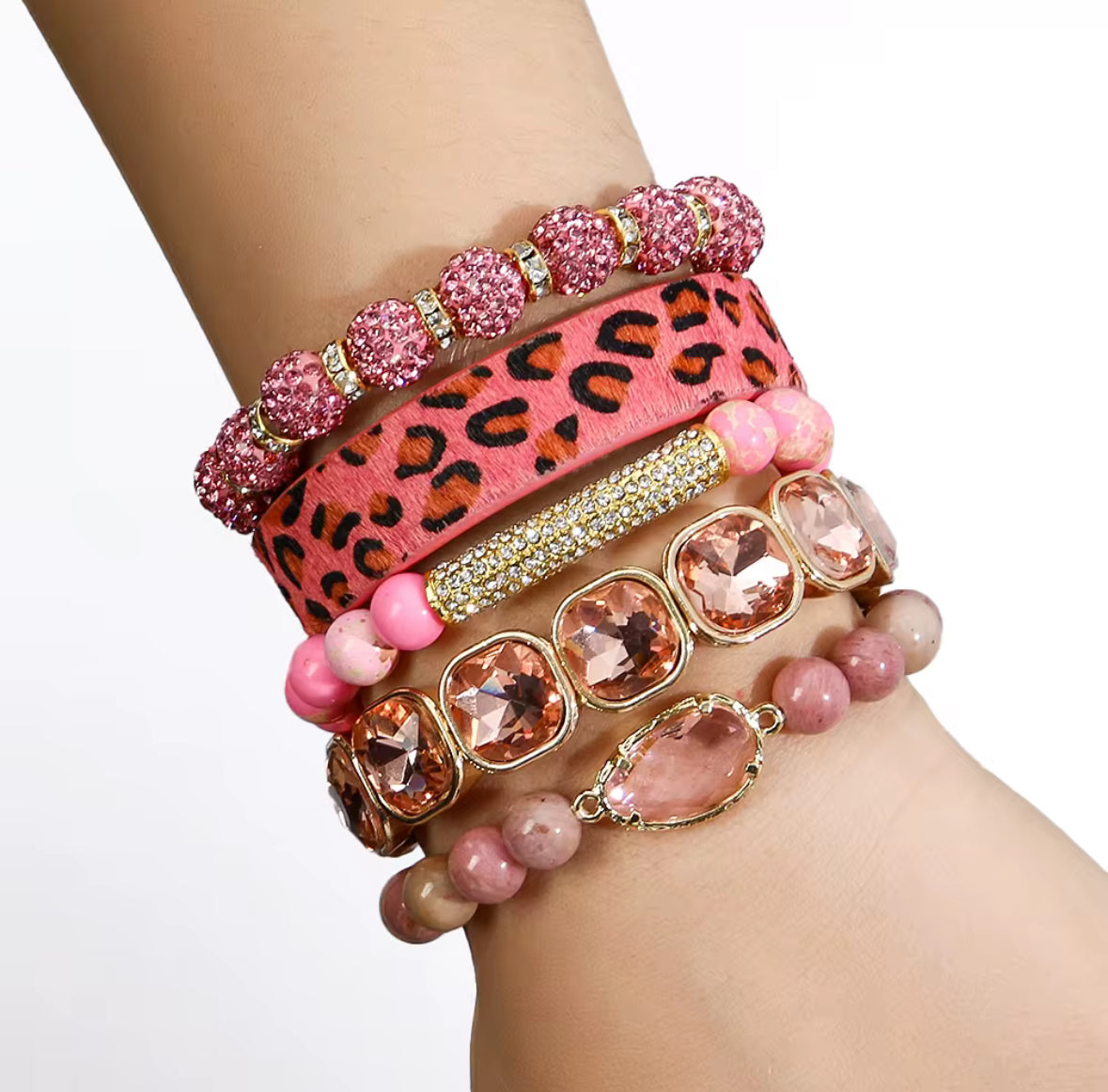 Pink leopard beaded bracelet stack featuring pink, gold, and leopard print beads on a wrist — Nubian Creations Co jewelry.