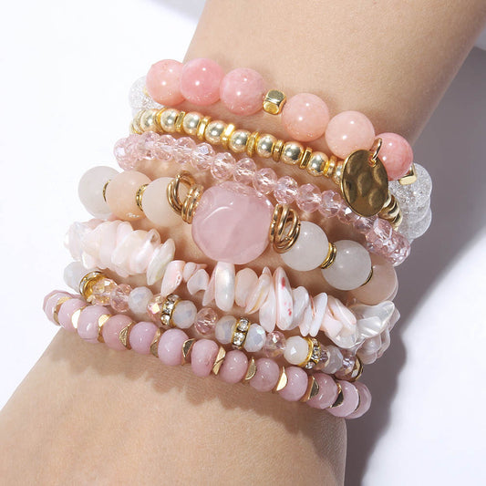 7 Piece womens crystal beaded gemstone bracelet set in rose quartz with gold accents.